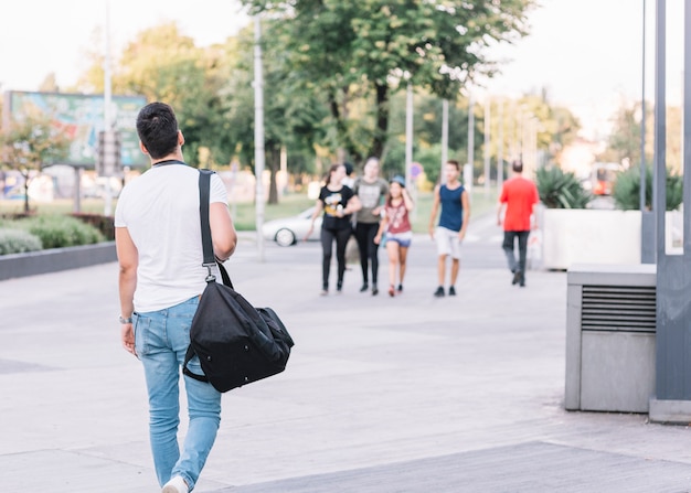 Rear view of a man walking on street