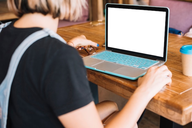 Free photo rear view of woman browsing laptop