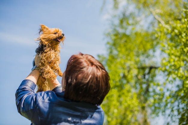 Rear view of woman with her cute dog