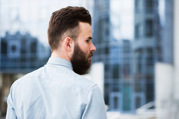 Rear view of a young businessman looking over his shoulder