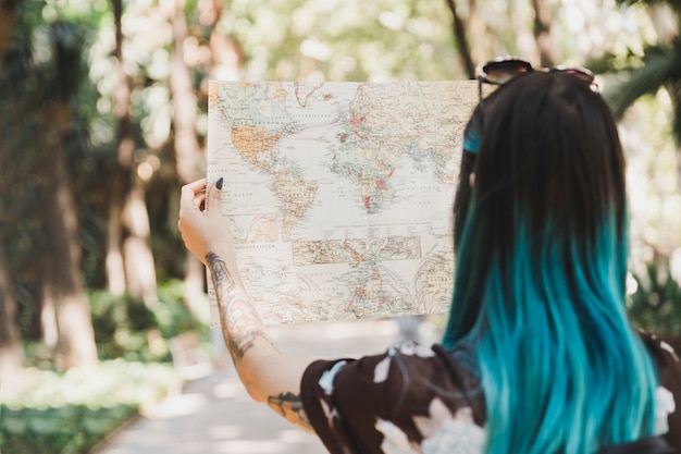 Free Photo rear view of young woman looking at map