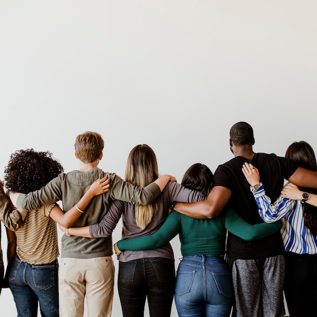 Rearview of diverse people hugging each other