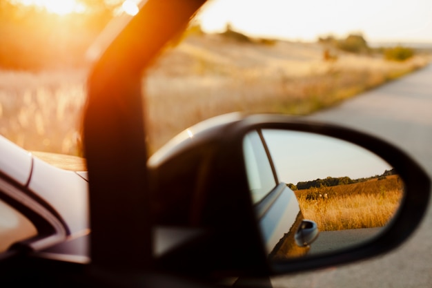 Free photo rearview mirror  on the sunset background