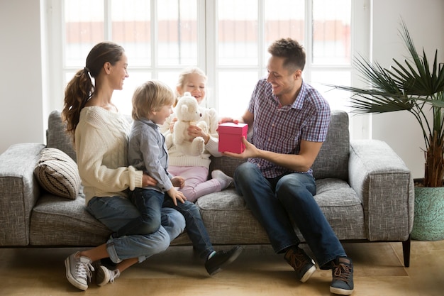 Receiving present on fathers day concept, family kids congratulating dad