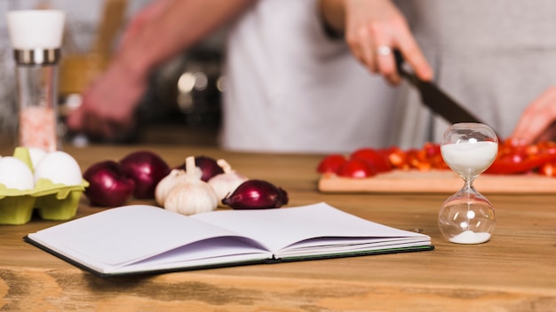 Recipe book and hourglass in kitchen