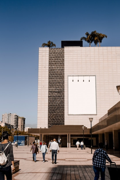 Rectangular white billboard on building wall in the city