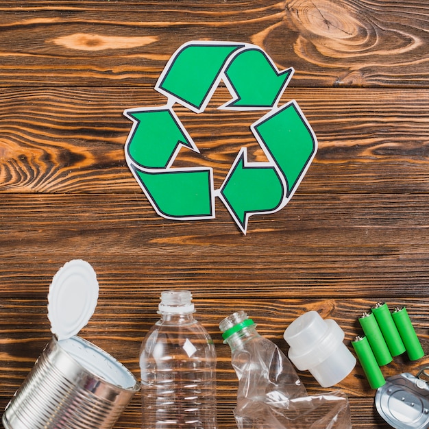 Recycle icon with recycle product on wooden textured backdrop