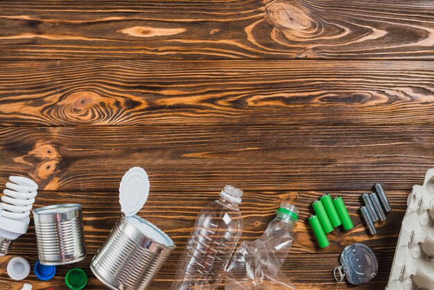 Recycle products arranged on bottom of wooden background