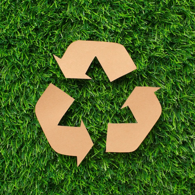 Recycle sign on grass