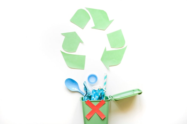 Recycle symbol and bin with plastic rubbish 