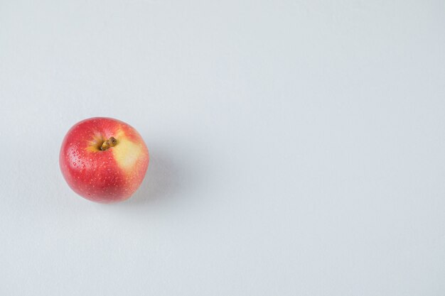 Red apple isolated on the textured surface