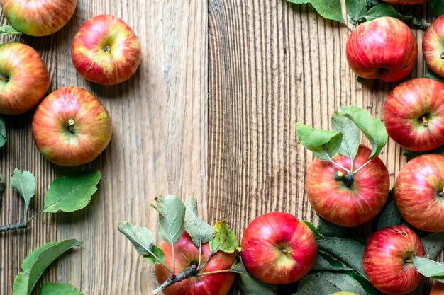 Red apple and leaf on wooden table