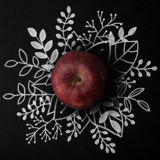 Free Photo red apple over outline floral hand drawn