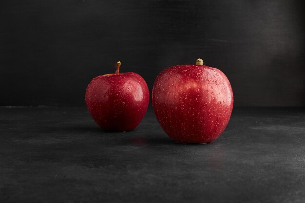 Red apples isolated on black background. 