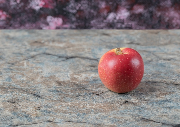 Red apples isolated on a concrete surface