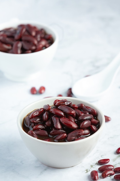 red bean boiled in white bowl place on white marble floor