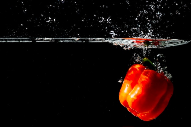 Red bell pepper floating under the clear water