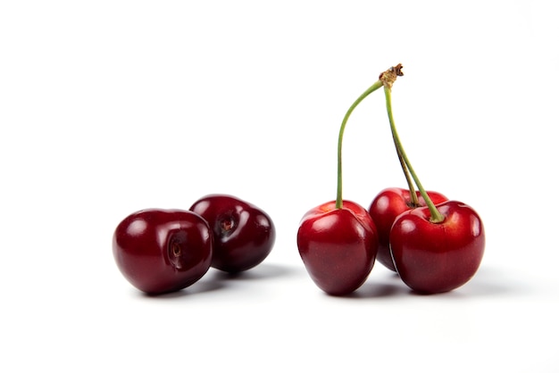 Red and black cherries on white background