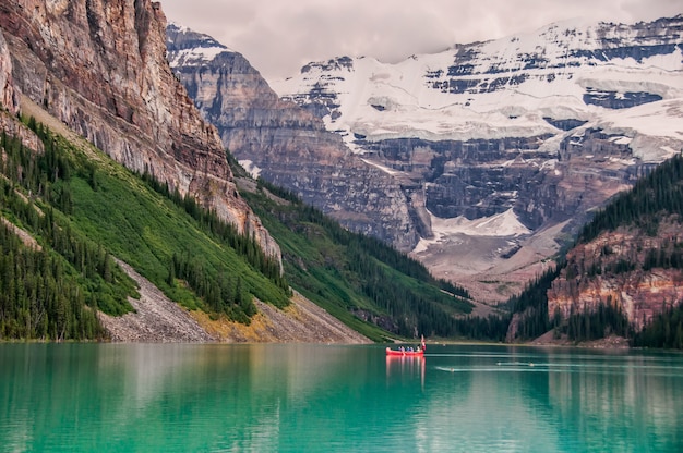 Free Photo red boat in the lake near mountain