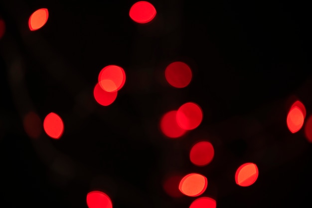 Free Photo red bokeh pattern on a dark background wallpaper