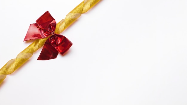 Free Photo red bow with golden ribbon