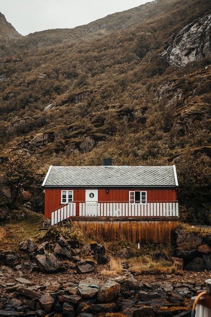 Red cabin near mountains and rocks