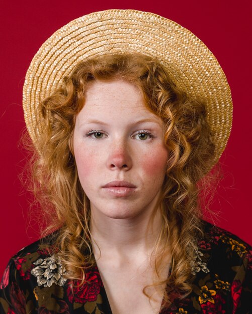 Red cheeked young ginger woman looking at camera