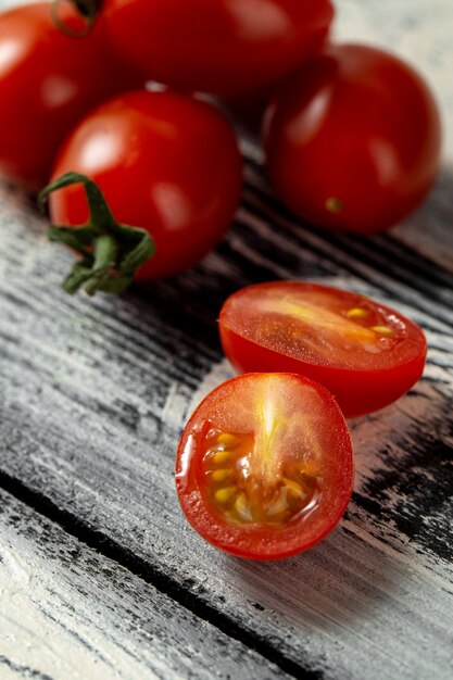 Red cherry tomatoes on grey wooden desk