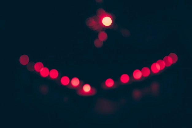 Red circular bokeh on dark background