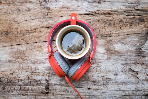 Free Photo red coffee cup, red headphone and chocolate chip cookies on the wooden table. view from above. coffee with chirstmas concept.