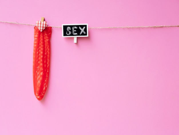 Free Photo red condom hanging on clothesline