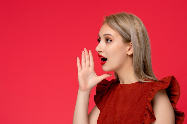 Free Photo red dress cute classy elegant girl in burgundy dress with red lipstick hands around mouth calling