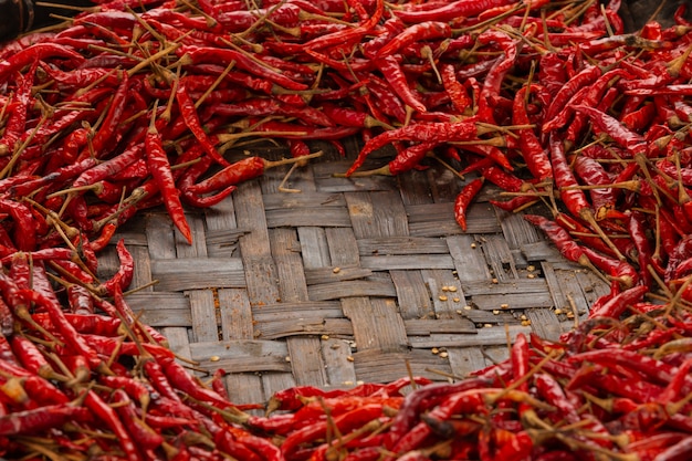 Free photo red dried chilies placed on the space on the weave.