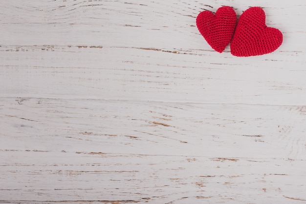 Red fabric hearts on a wooden table