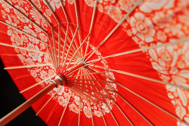 Red floral wagasa umbrella in studio low angle