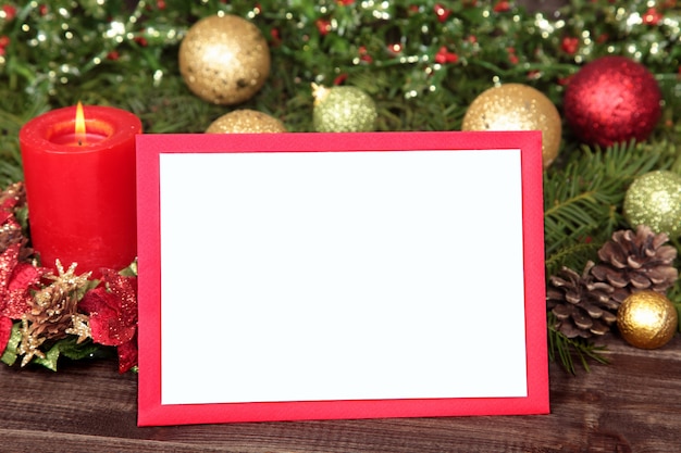 Red frame with a candle and christmas ornaments