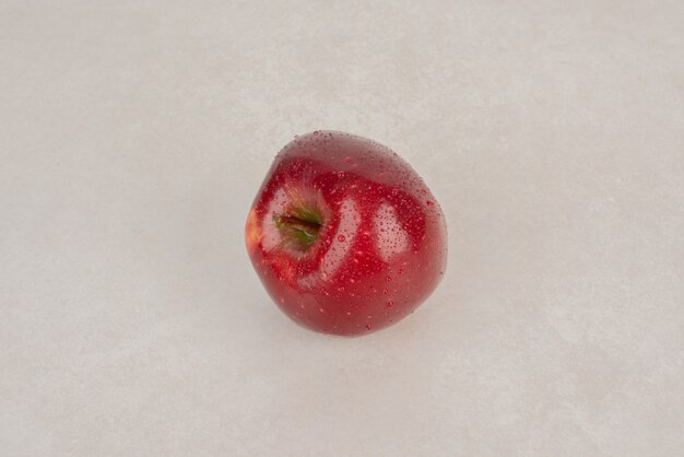 A red, fresh apple on white background .