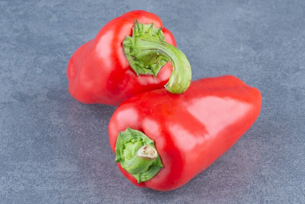 Red fresh peppers on marble.