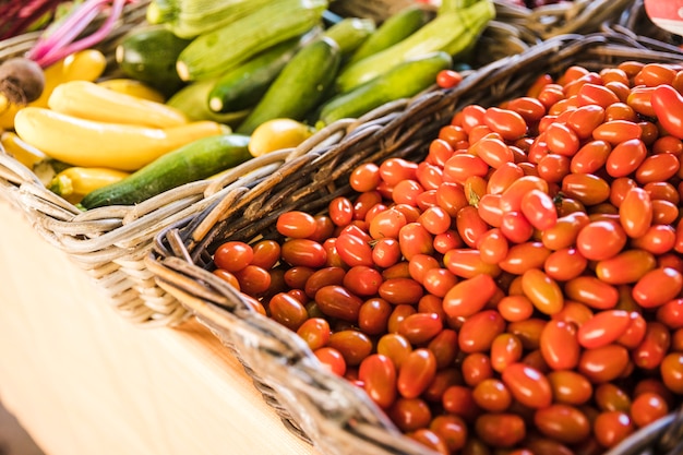 Red fresh tomatoes and organic zucchini at vegetable market