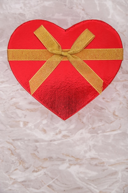 Free photo red gift box with golden bow