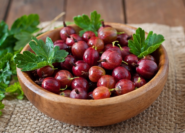 Red gooseberries in a wooden bowl