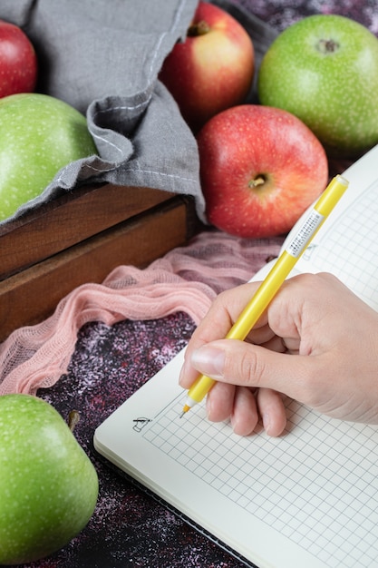 Red green apples and a checked recipe book