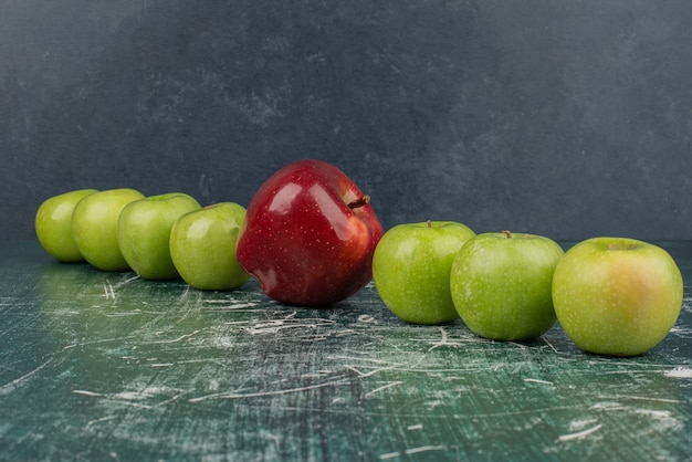 Free Photo red and green apples on marble table.