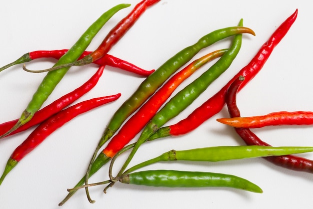 Free photo red and green peppers on plain background