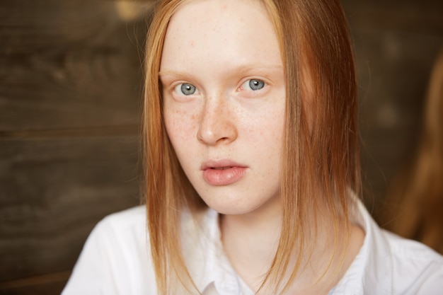 Red-haired woman sitting in cafe