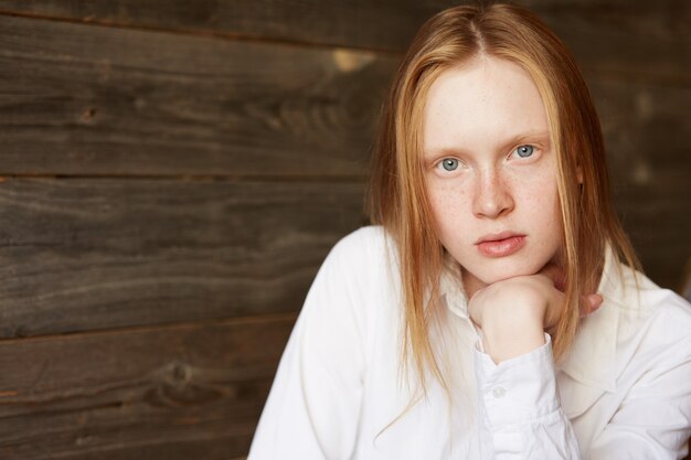 Red-haired woman sitting in cafe