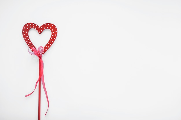 Free photo red heart on stick with ribbon