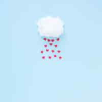 Free photo red hearts falling from cloud