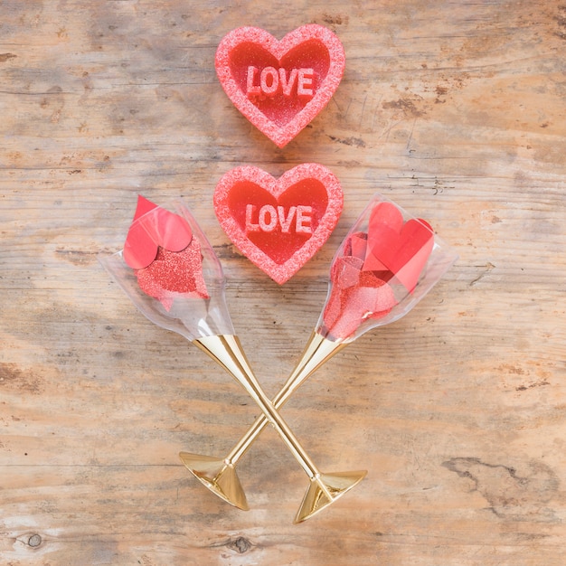 Free photo red hearts in glasses on wooden table