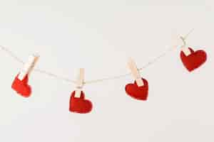 Free photo red hearts hanging on rope